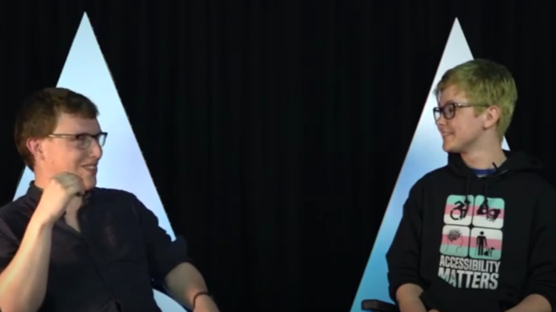 Two people seated in conversation.