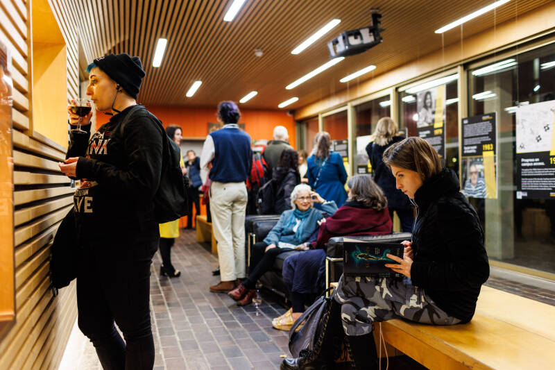 People gathered for the exhibition and film screening: Our Stories, on 6 December 2022 in Marlowe Building