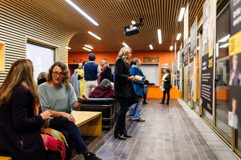People gathered for the exhibition and film screening: Our Stories, on 6 December 2022 in Marlowe Building
