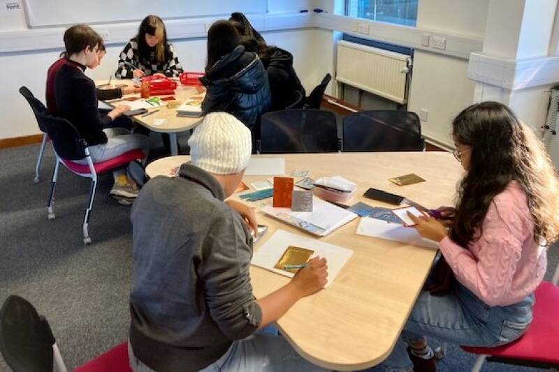 Picture of students taking part in a wellbeing creative workshop including finger casting in December 2022 as part of DHM