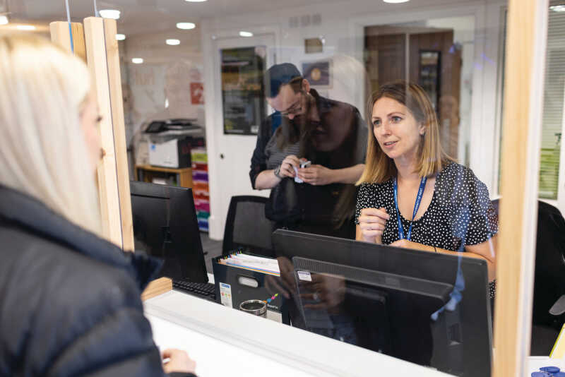 A student getting help from a staff member