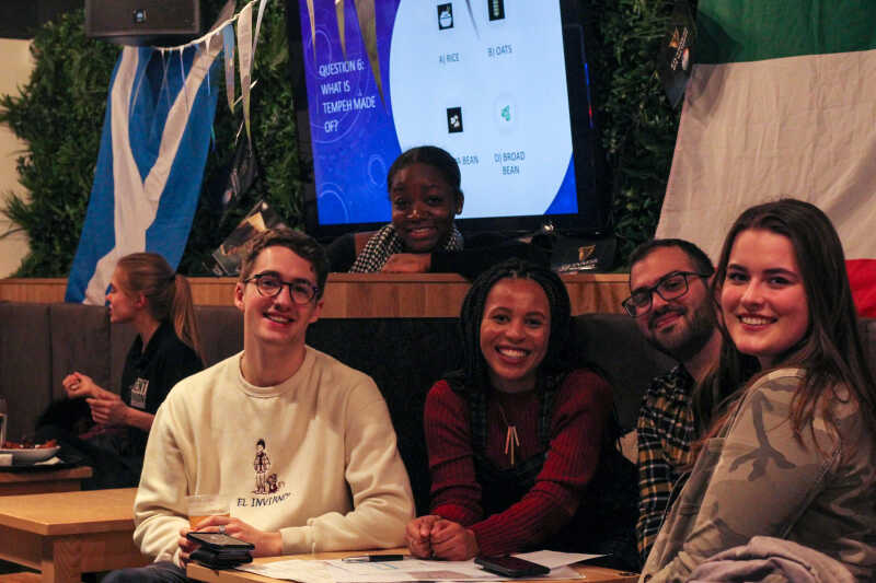 Kent Global Officers sitting in a bar smiling at the camera