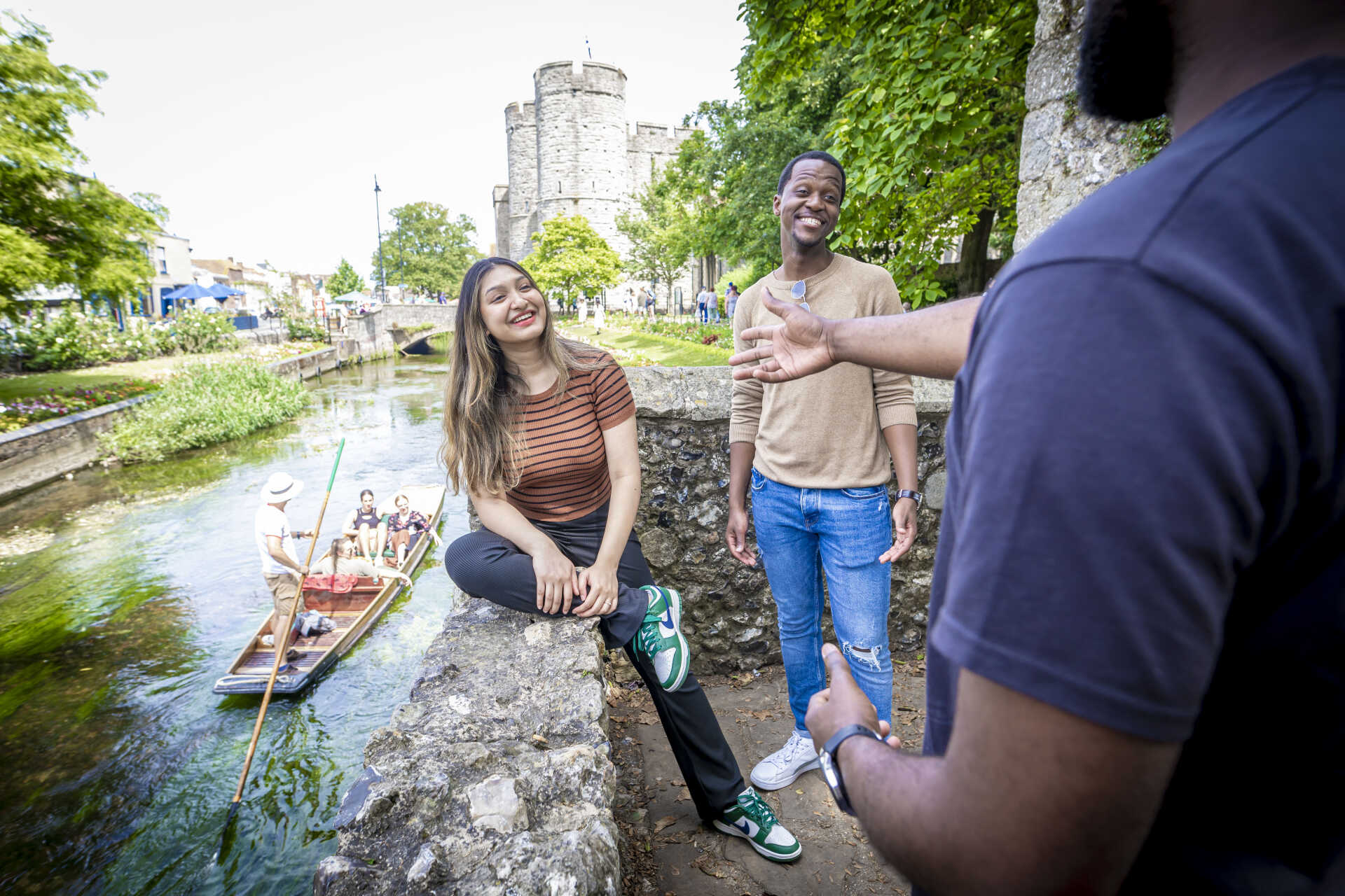 students laughing by river
